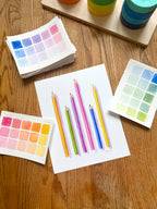colorful watercolor of pencils archival print, surrounded by geometric toys on a wooden surface.  hand-painted by katie sinclair and perfect for a playroom or kid bedroom.