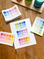 colorful watercolor swatch art print, surrounded by geometric toys on a wooden surface.  hand-painted by katie sinclair and perfect for a playroom or kid bedroom.