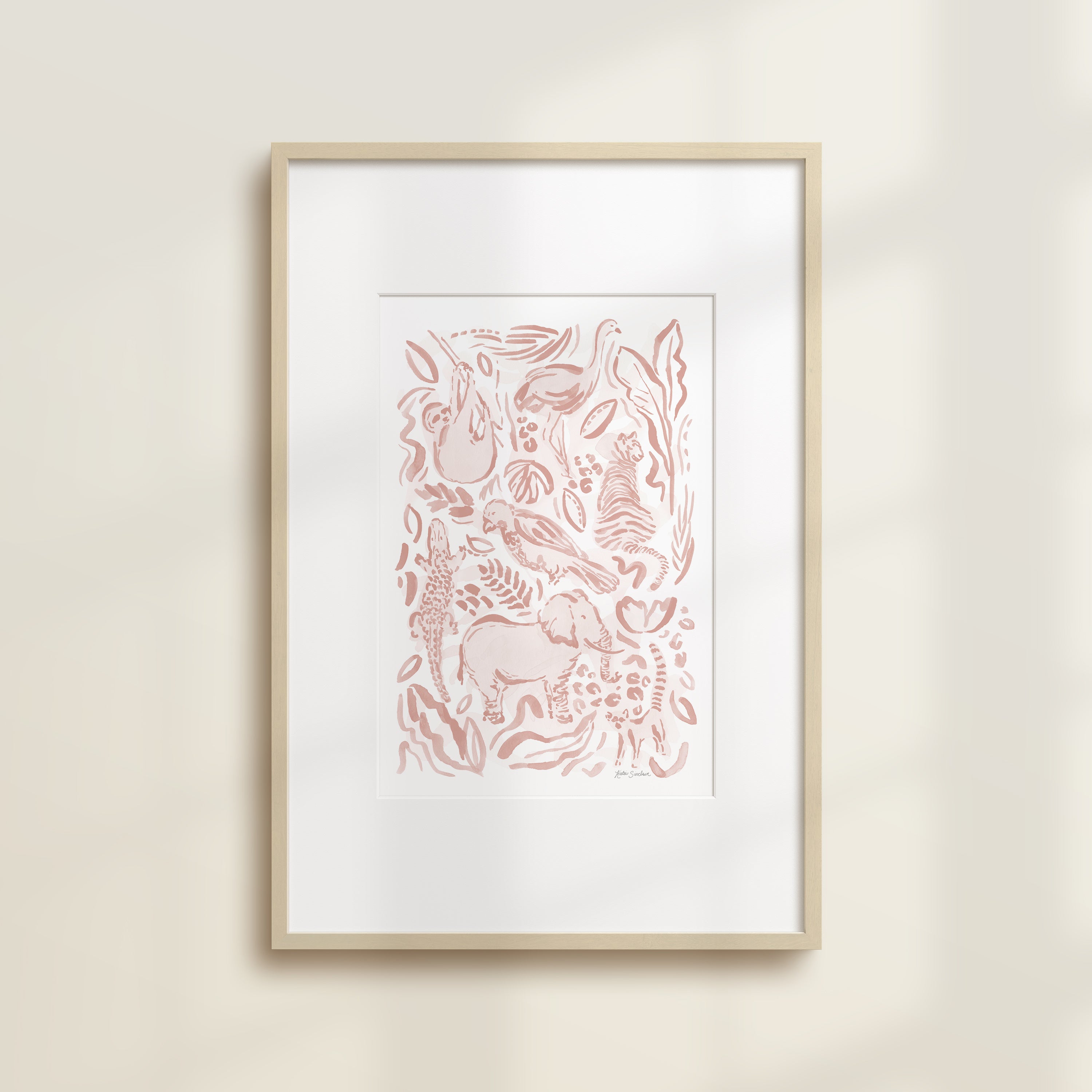 The Safari Jungle Elephant by Katie Sinclair watercolor print in the pink blush colorway, in a wooden frame with a white mat.