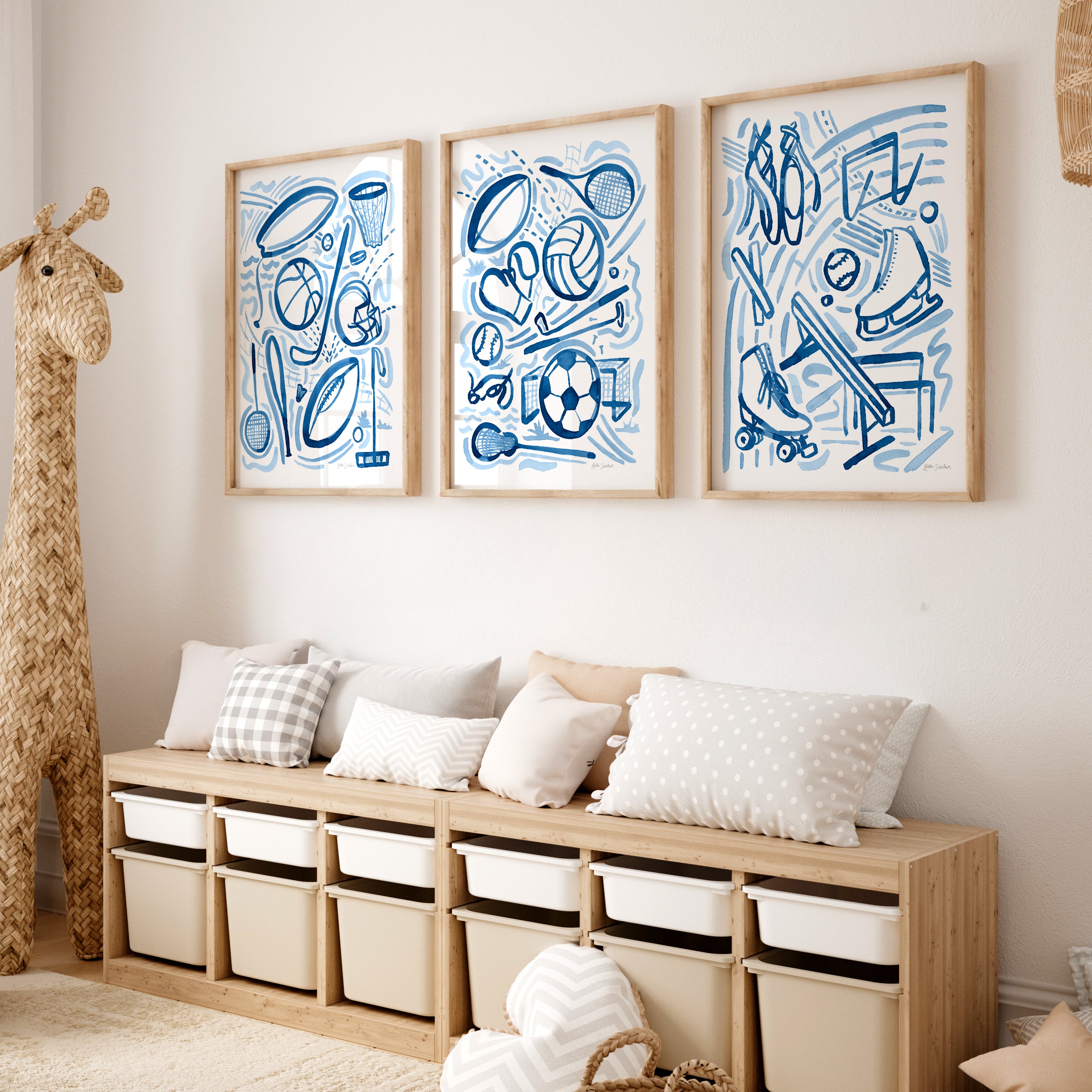Wooden bench with storage bins against a wall with framed blue sports-themed artwork.
