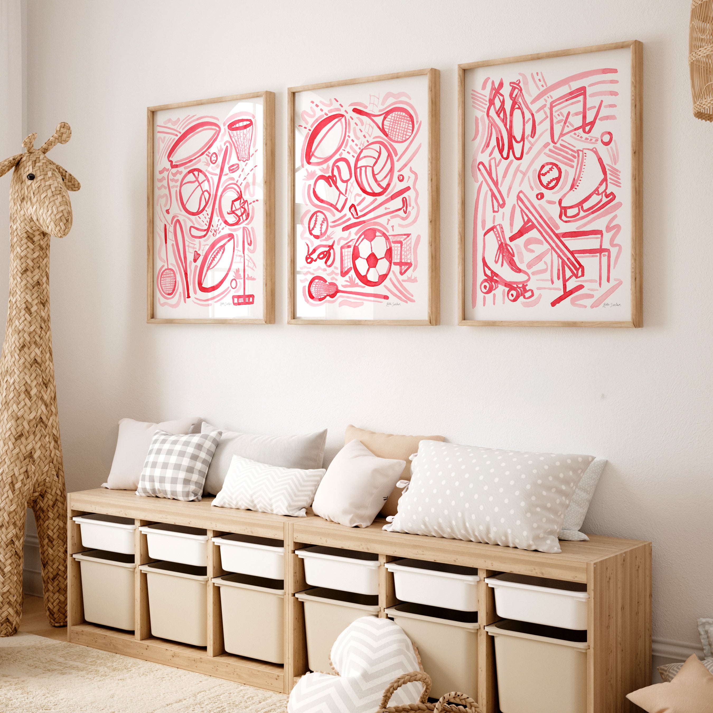 Wooden bench with storage bins against a wall with framed sports pink watercolor abstract art