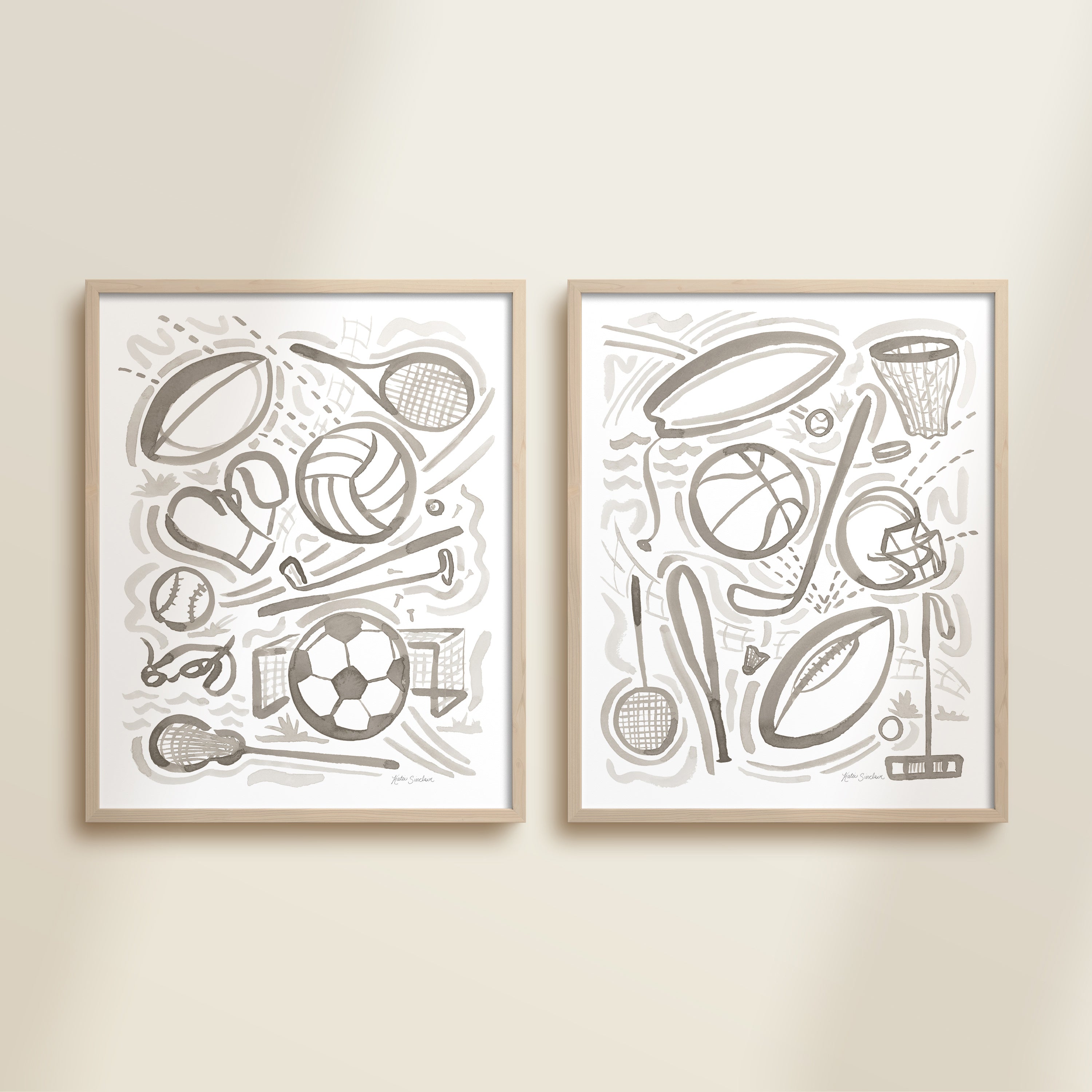 Two framed gray playful sports watercolor art prints in frames featuring tennis, soccer, ballet and baseball for kids nursery or playroom wall décor.  