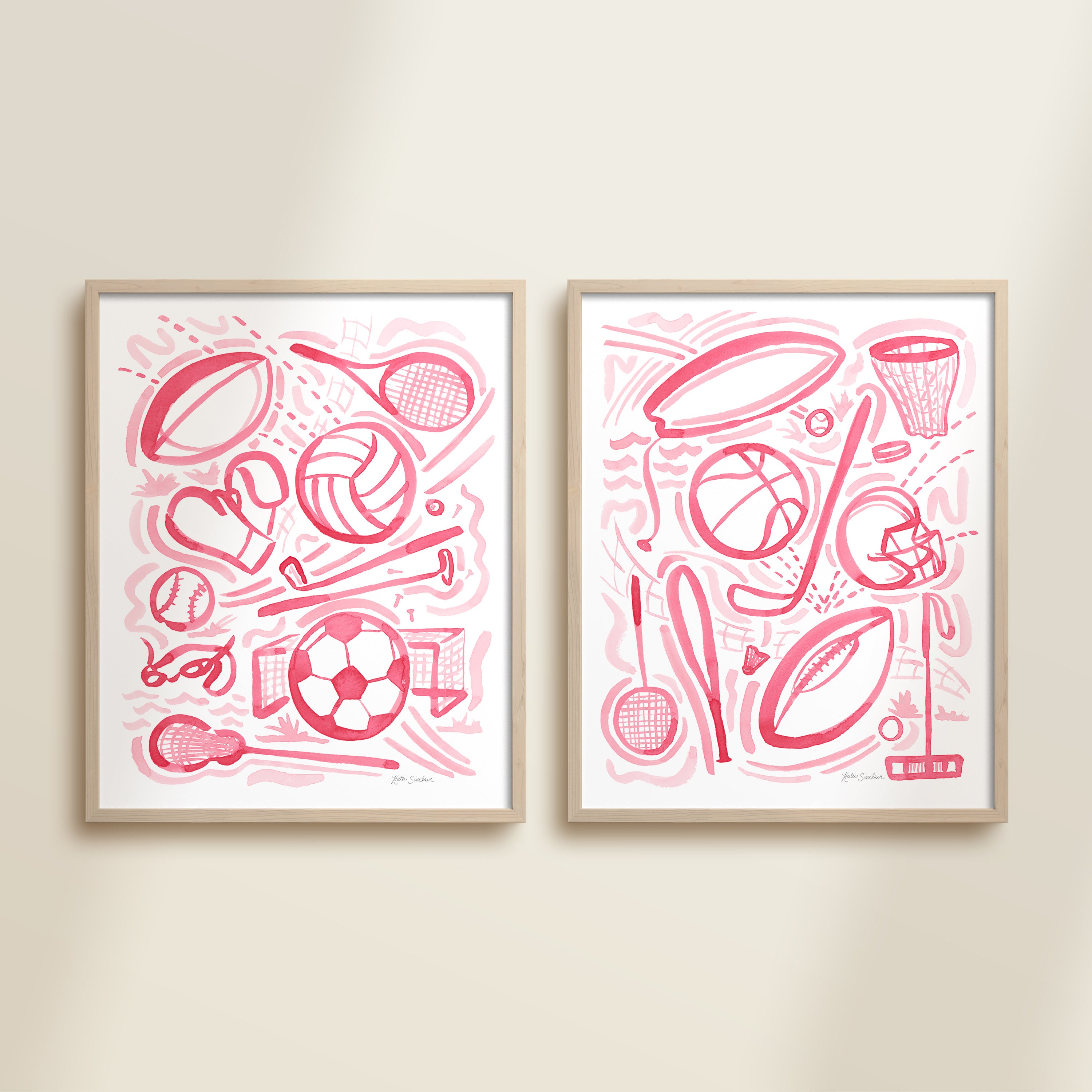 Two framed pink playful sports watercolor art prints in frames featuring tennis, soccer, ballet and baseball for kids nursery or playroom wall décor.  
