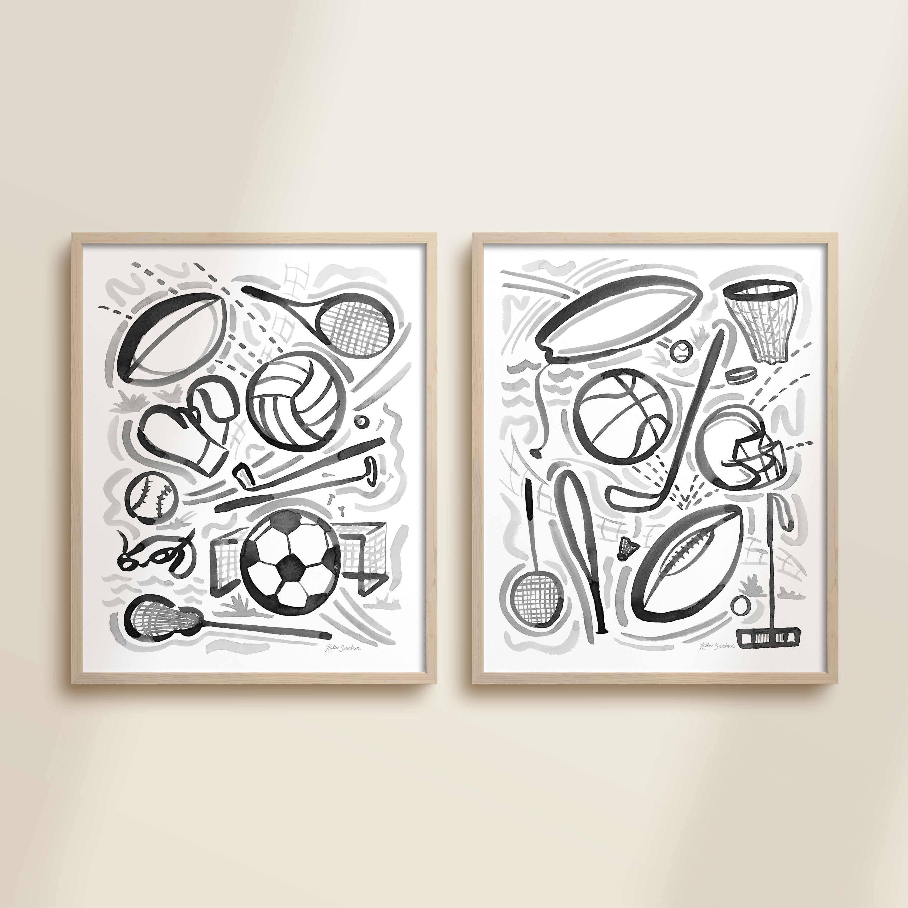 Two framed black and white playful sports watercolor art prints in frames featuring tennis, soccer, ballet and baseball for kids nursery or playroom wall décor.  