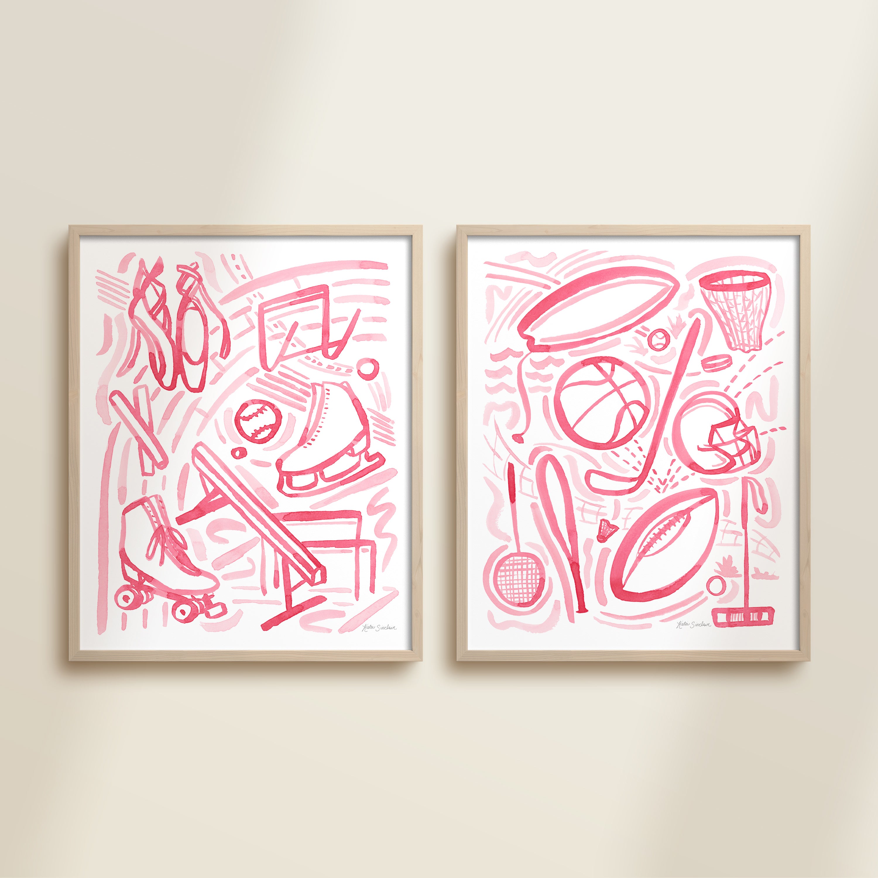 Two framed pink playful sports watercolor art prints in frames featuring tennis, soccer, ballet and baseball for kids nursery or playroom wall décor.