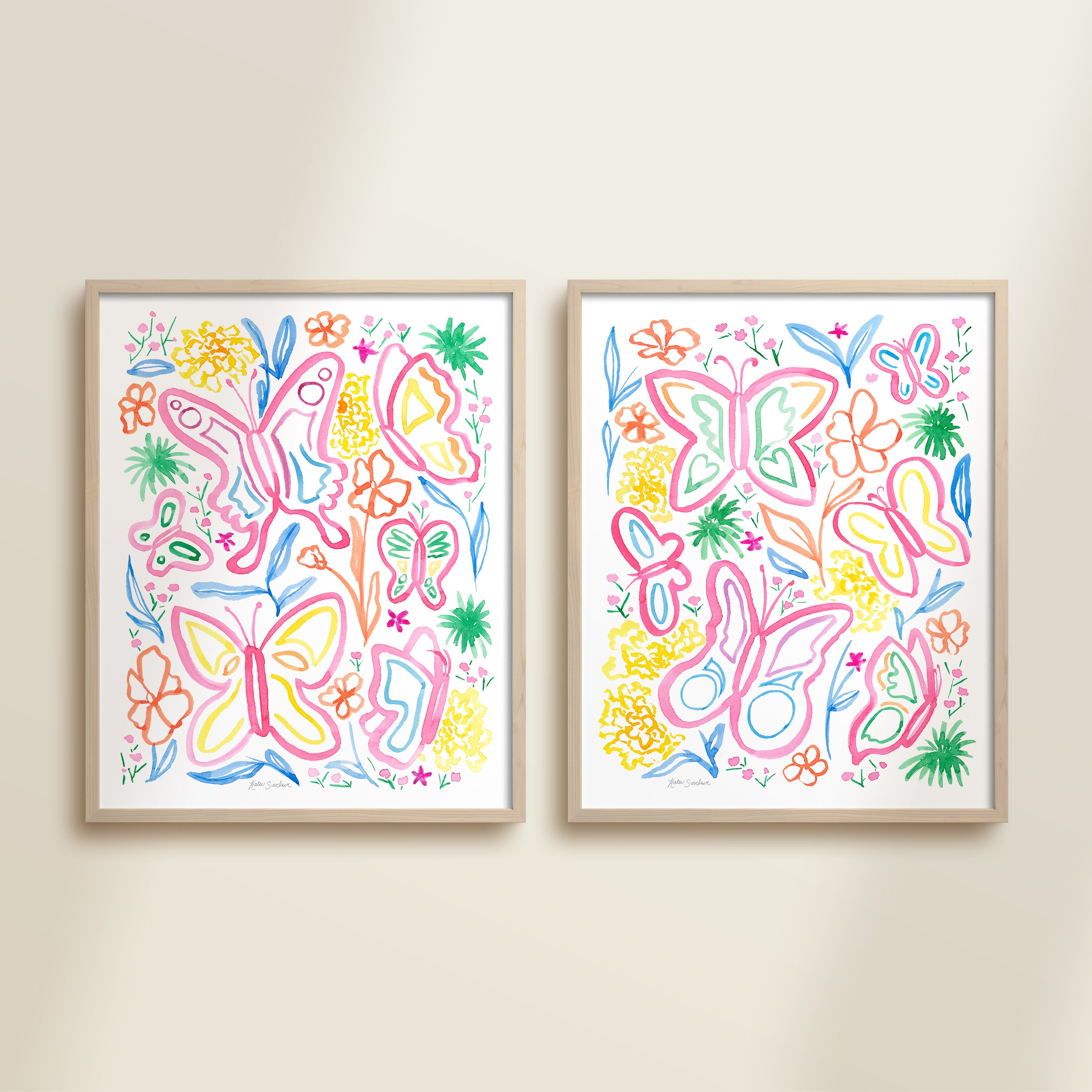 Two framed colorful pink, yellow, blue, green, and orange watercolor garden-themed artworks on a beige wall, featuring a butterflies and flowers.