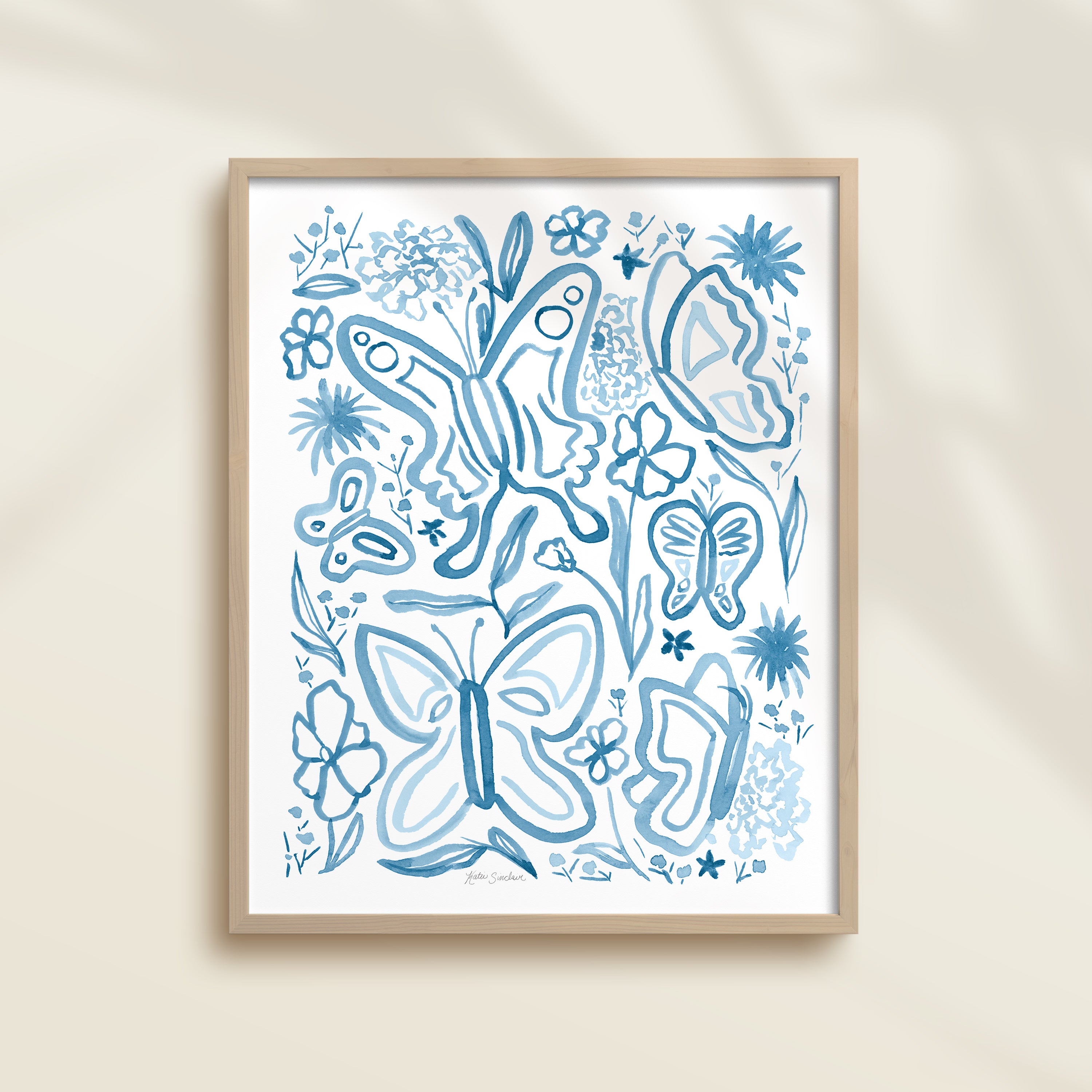 Framed hand-painted blue watercolor artwork with garden motifs, including butterflies and flowers.