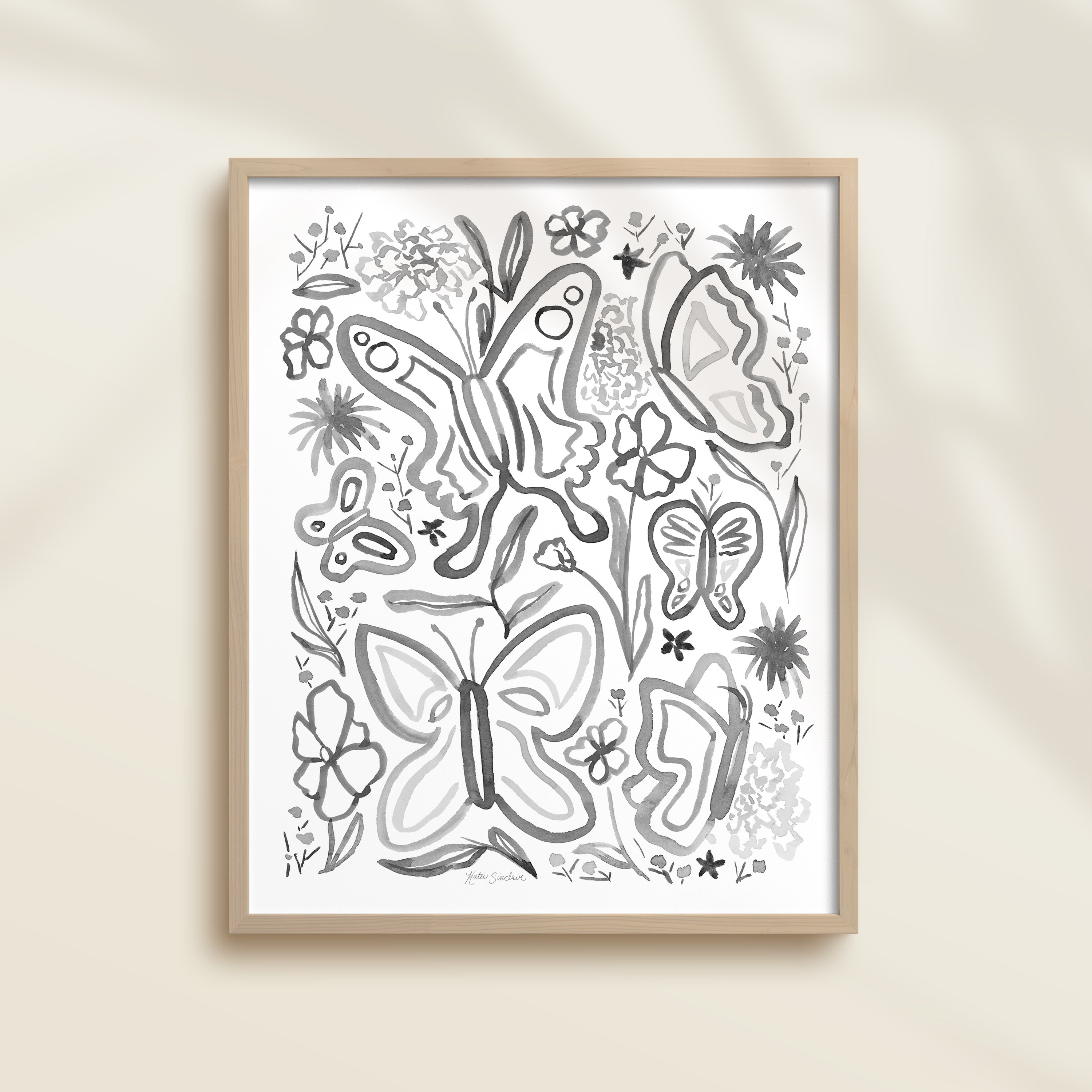 Framed hand-painted black and white watercolor artwork with garden motifs, including butterflies and flowers.