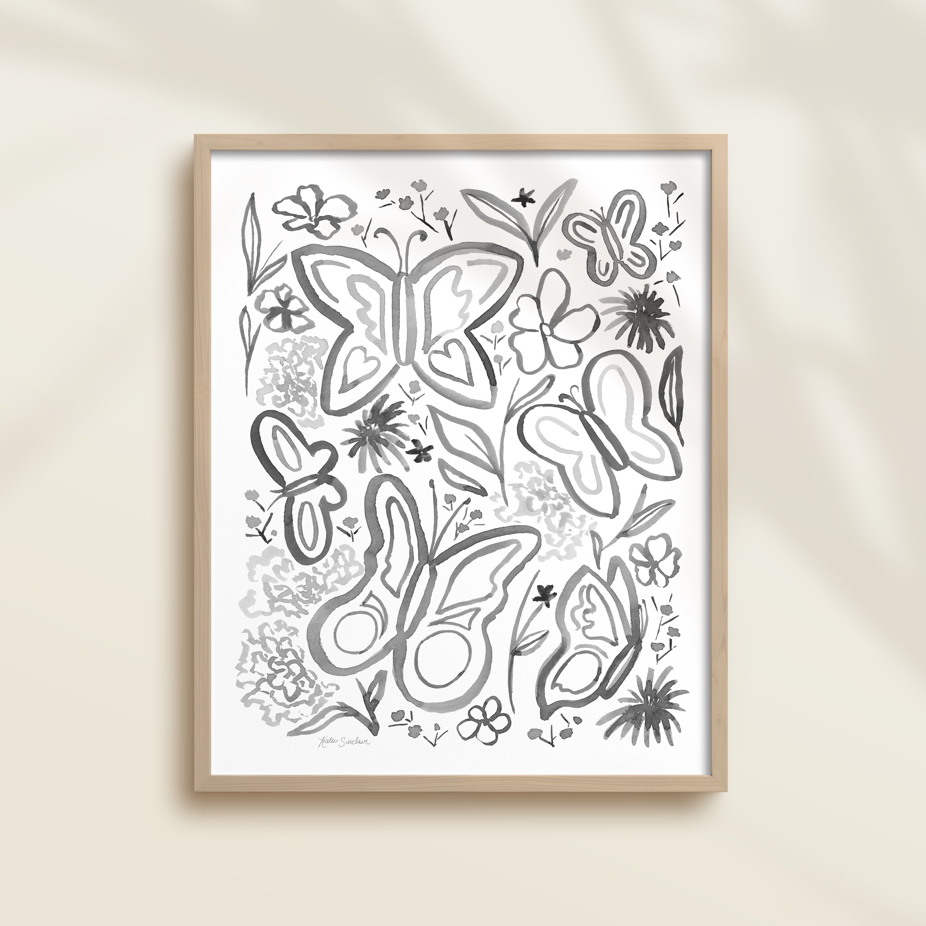 Framed hand-painted black and white watercolor artwork with garden motifs, including butterflies and flowers.