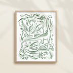 Framed hand-painted watercolor abstract artwork with green dinosaur illustrations on a light background, featuring a brontosaurus, spinosaurus, raptor, and pterodactyl. 