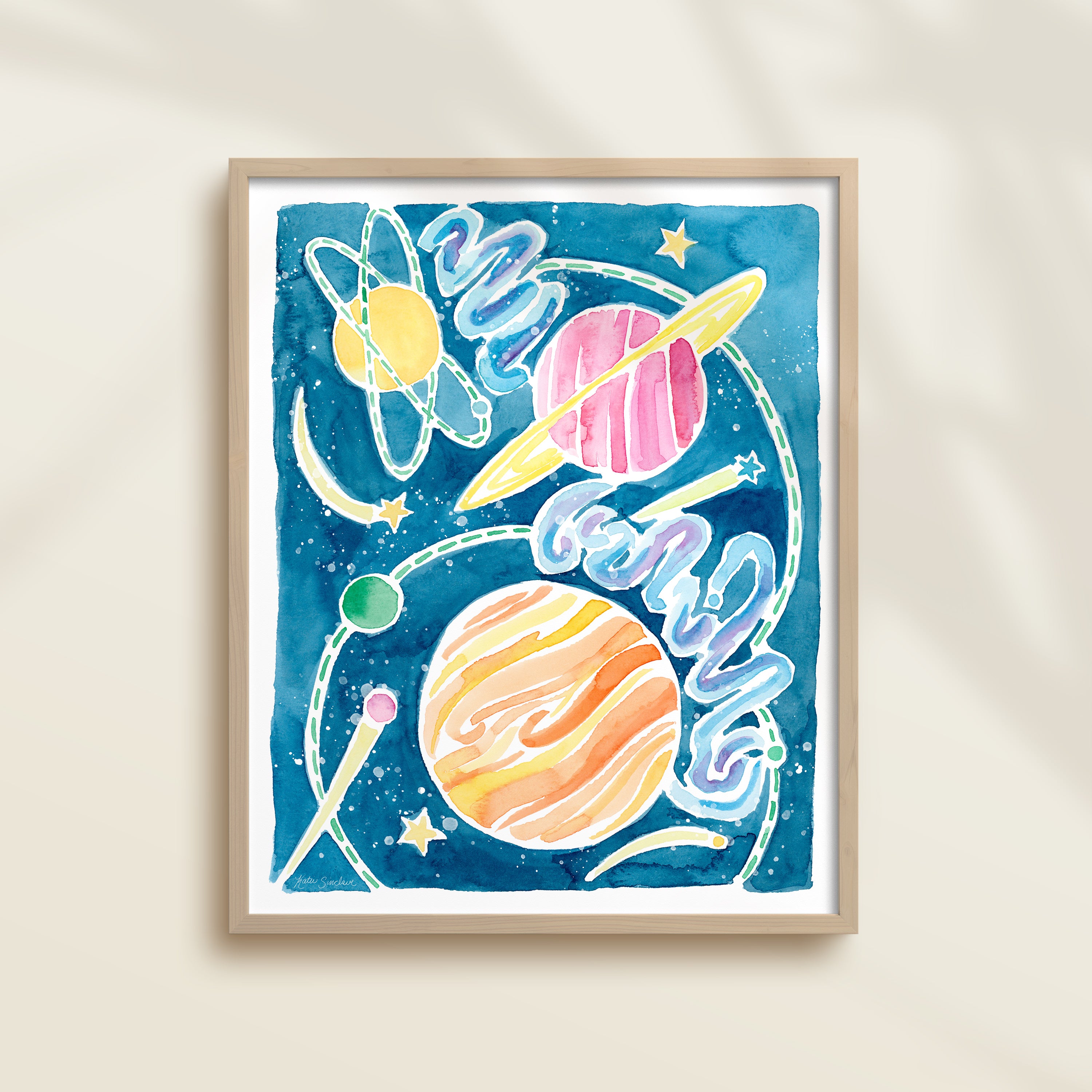 Framed colorful watercolor artwork of space-themed design with planets, stars, and a galaxy.