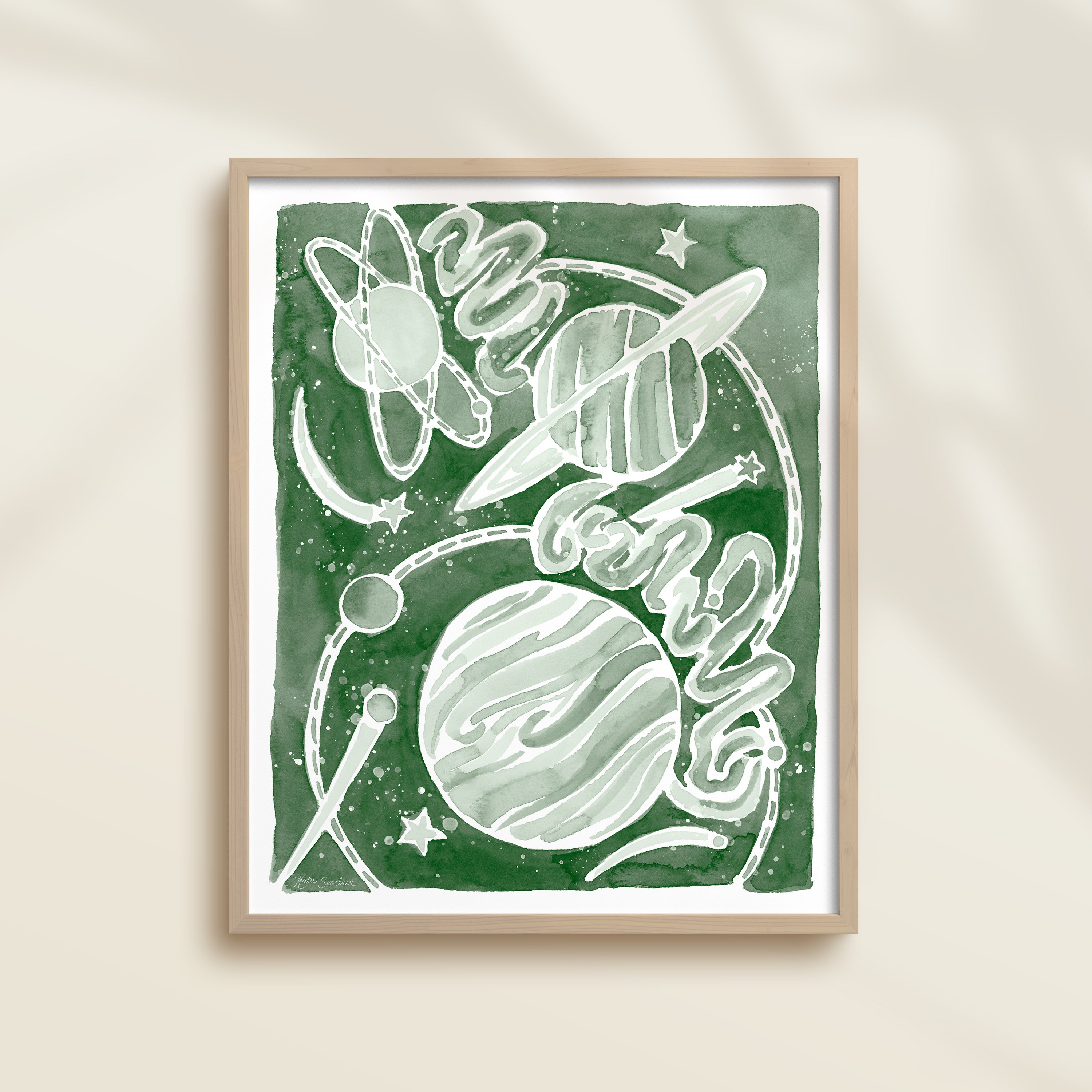 Framed green watercolor artwork of space-themed design with planets, stars, and a galaxy.