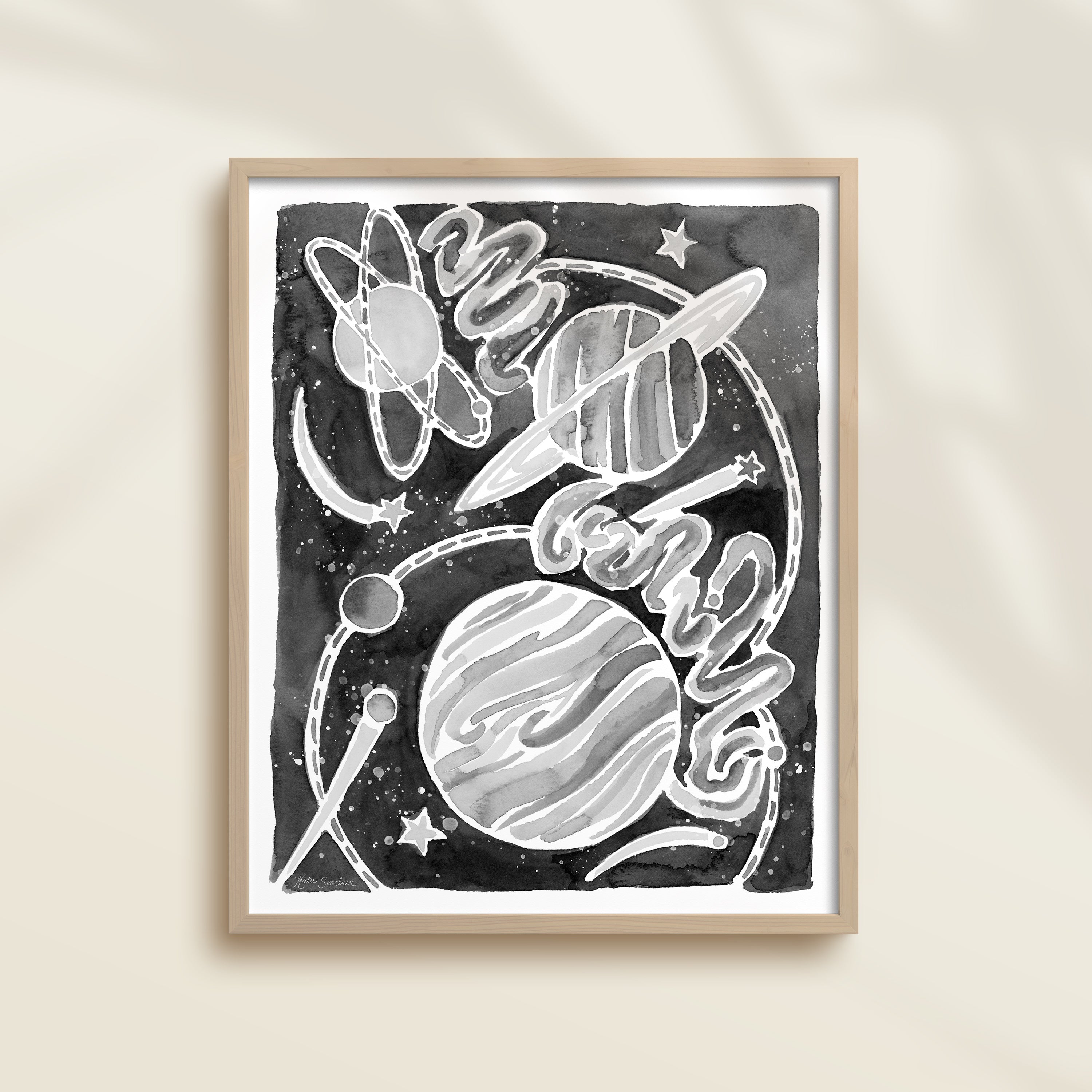 Framed black and white watercolor artwork of space-themed design with planets, stars, and a galaxy.