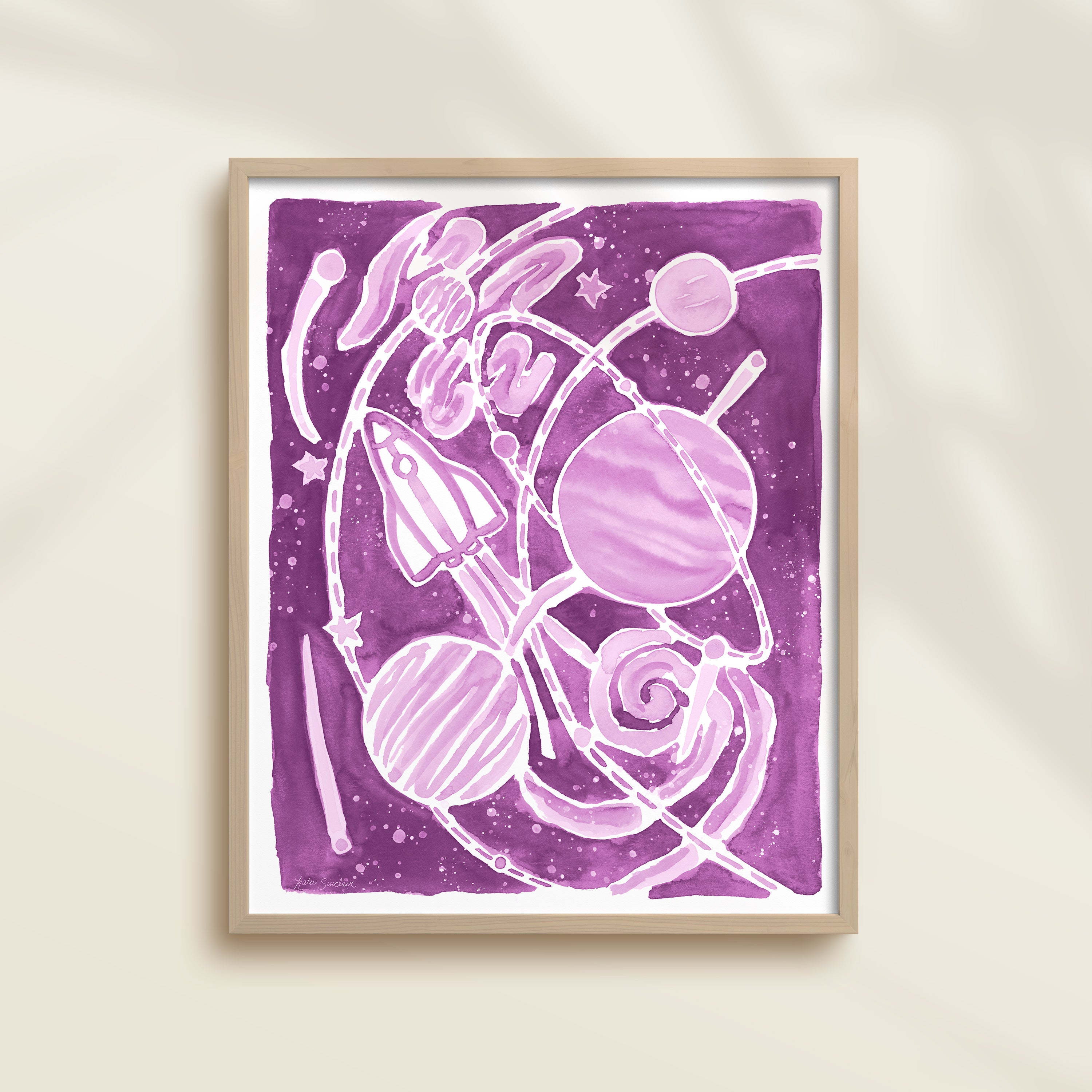Framed purple watercolor artwork of space-themed design with planets, stars, and a rocket ship.