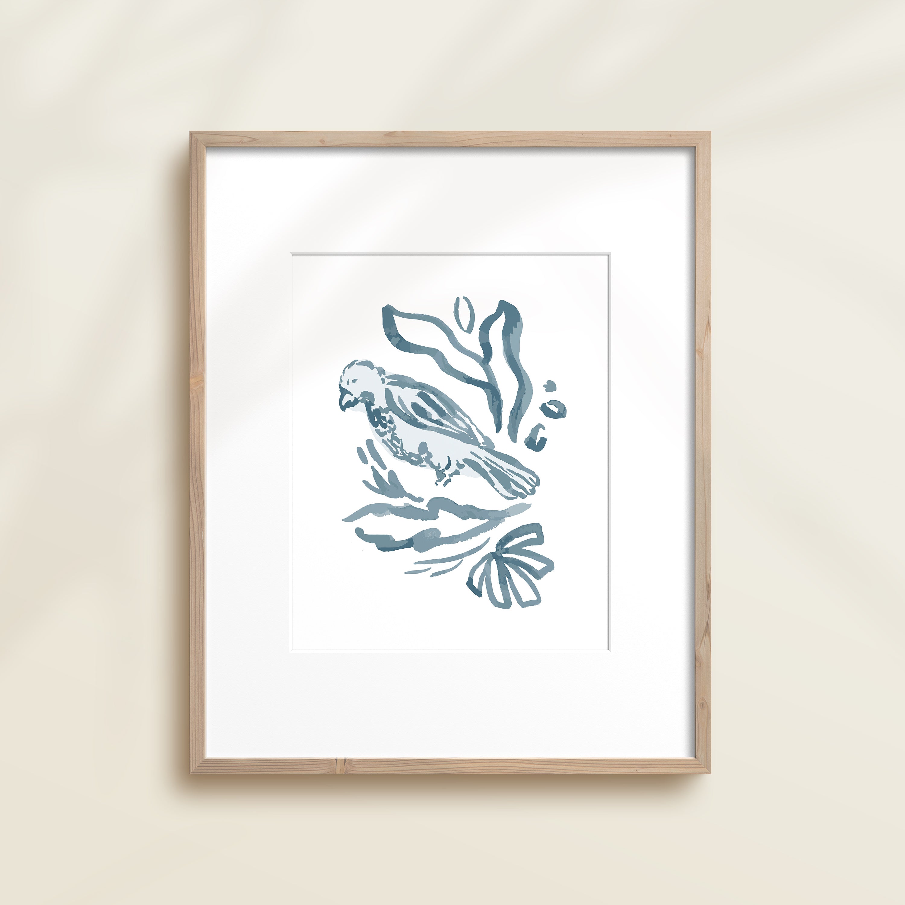 A framed watercolor print by Katie Sinclair of a bird surrounded by  foliage, displayed on a wall.  This image showcases the blue color version.