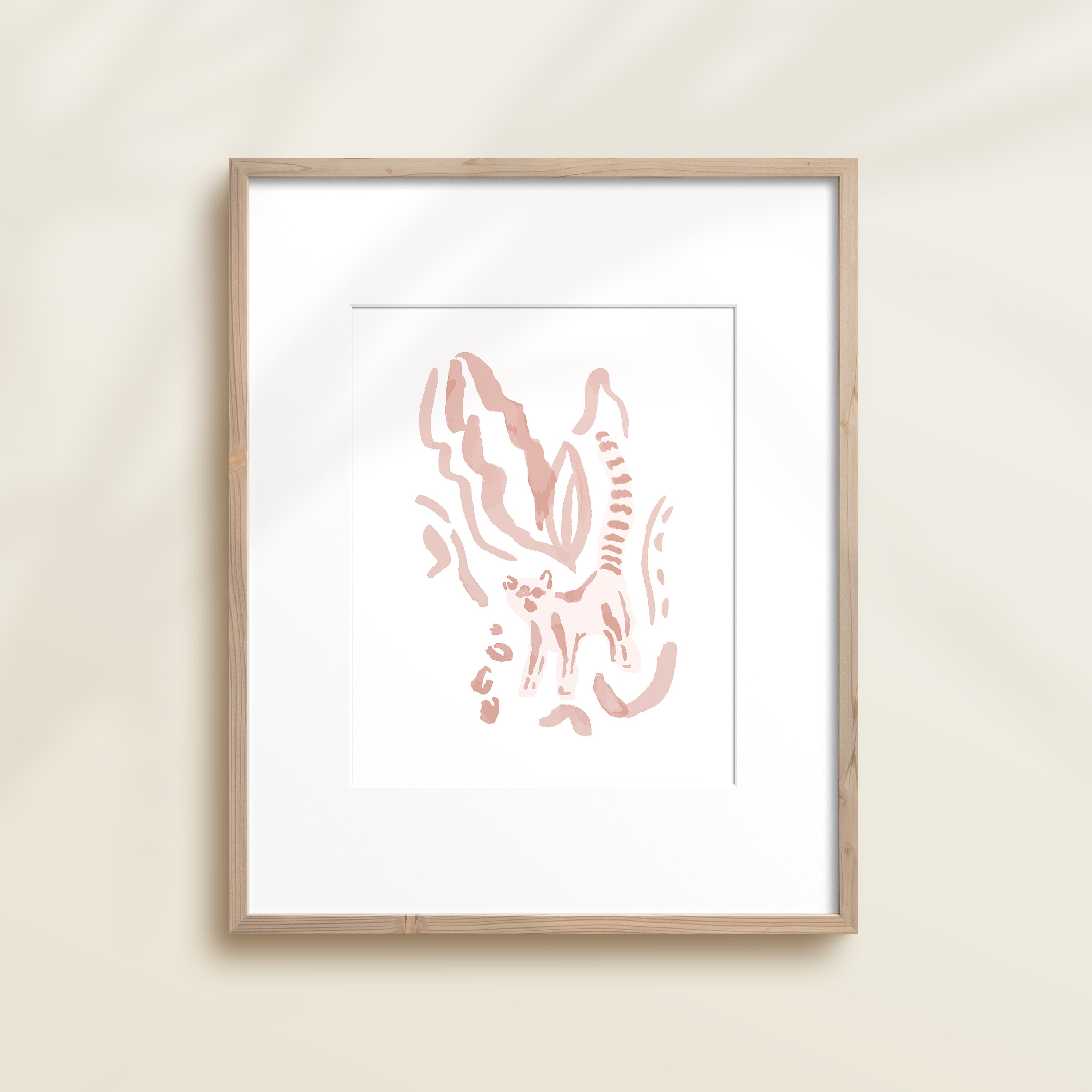 A framed watercolor print by Katie Sinclair of a lemur surrounded by  foliage, displayed on a wall.  This image showcases the pink color version.