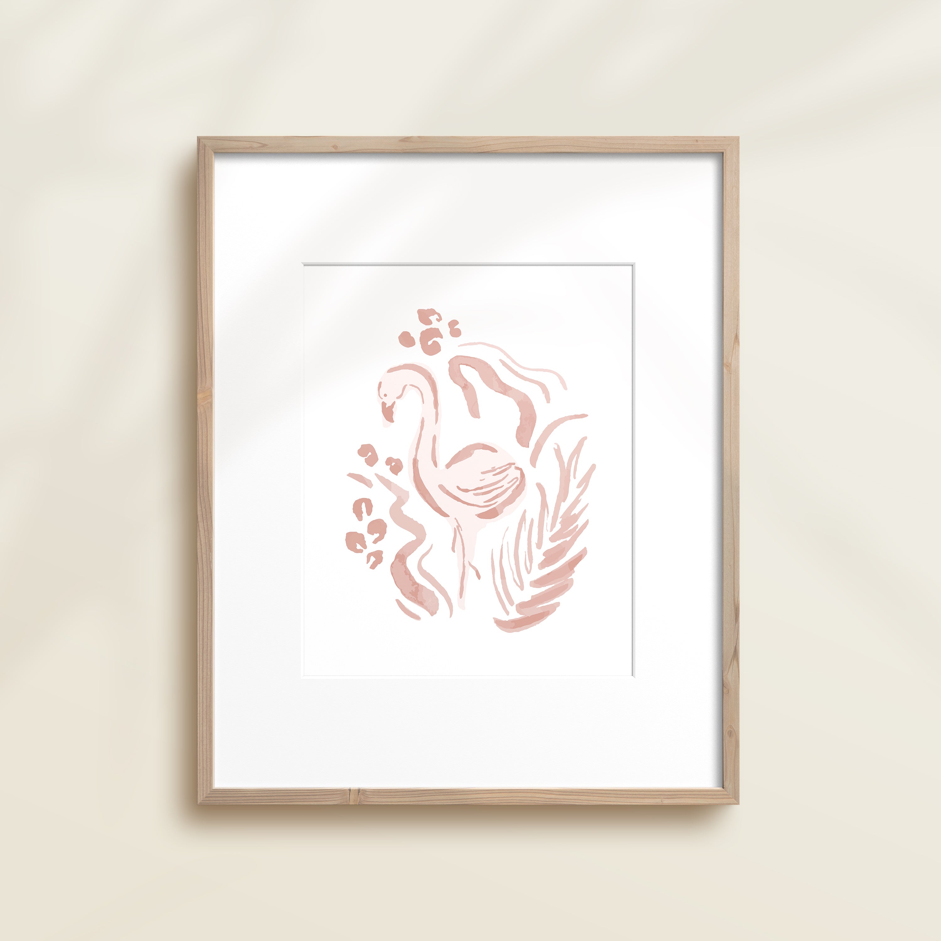A framed watercolor print by Katie Sinclair of a flamingo surrounded by  foliage, displayed on a wall.  This image showcases the pink color version.