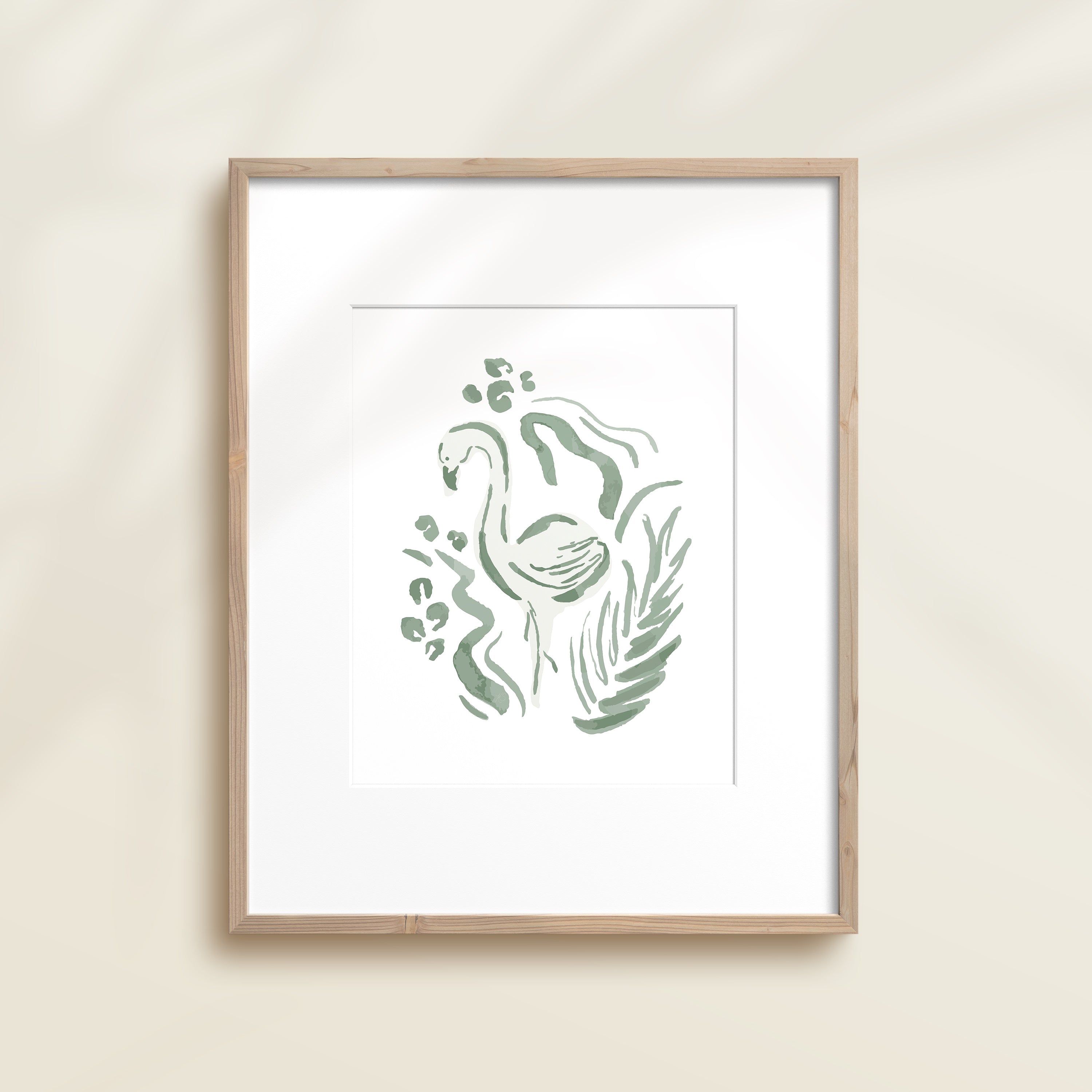A framed watercolor print by Katie Sinclair of an flamingo surrounded by  foliage, displayed on a wall.  This image showcases the green color version.