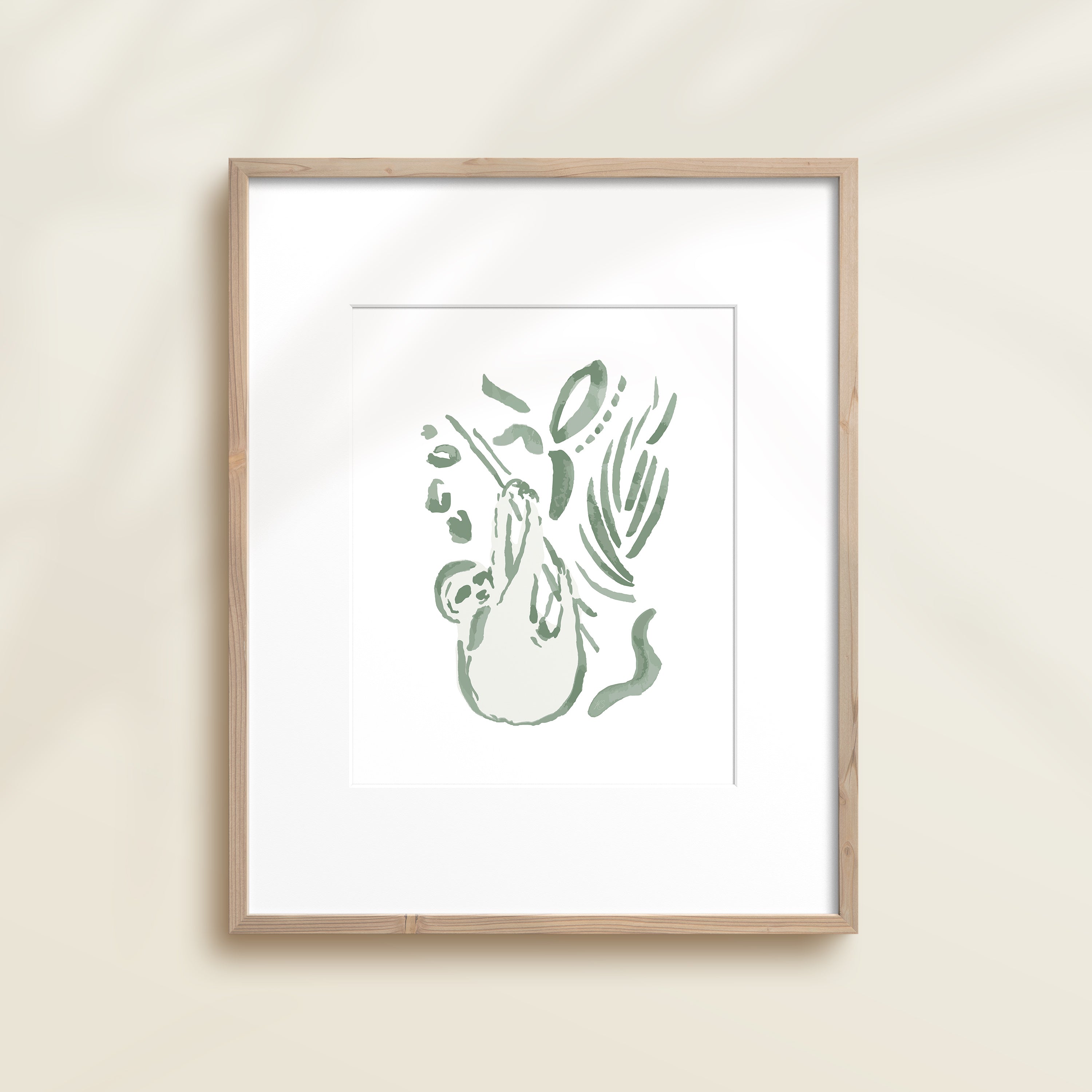 A framed watercolor print by Katie Sinclair of an sloth surrounded by  foliage, displayed on a wall.  This image showcases the green color version.