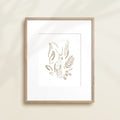 A framed watercolor print by Katie Sinclair of an antelope surrounded by  foliage, displayed on a wall.  This image showcases the gray color version.