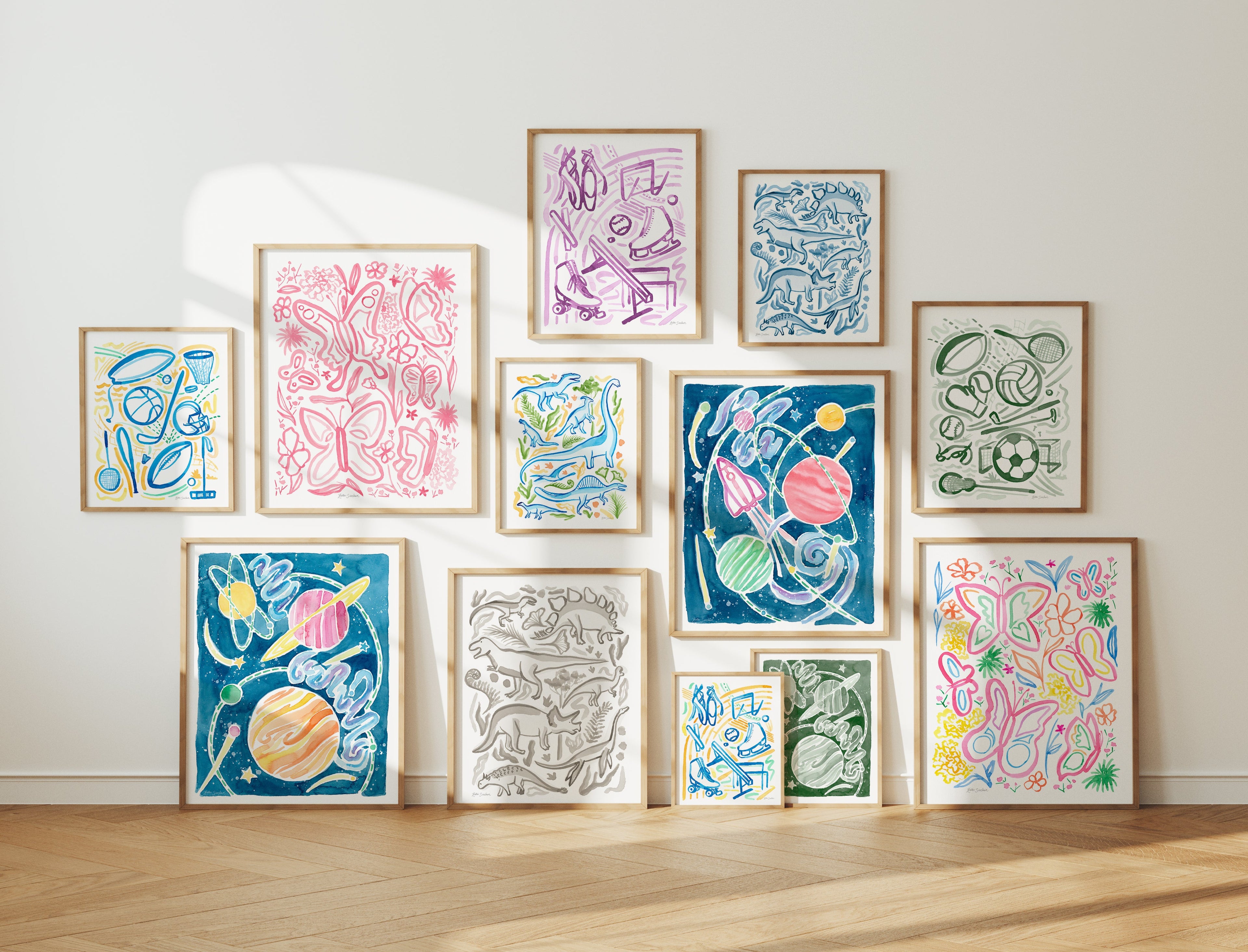 Collection of colorful framed watercolor artworks on a wall by Katie Sinclair. Perfect for playful kids rooms or nuseries.