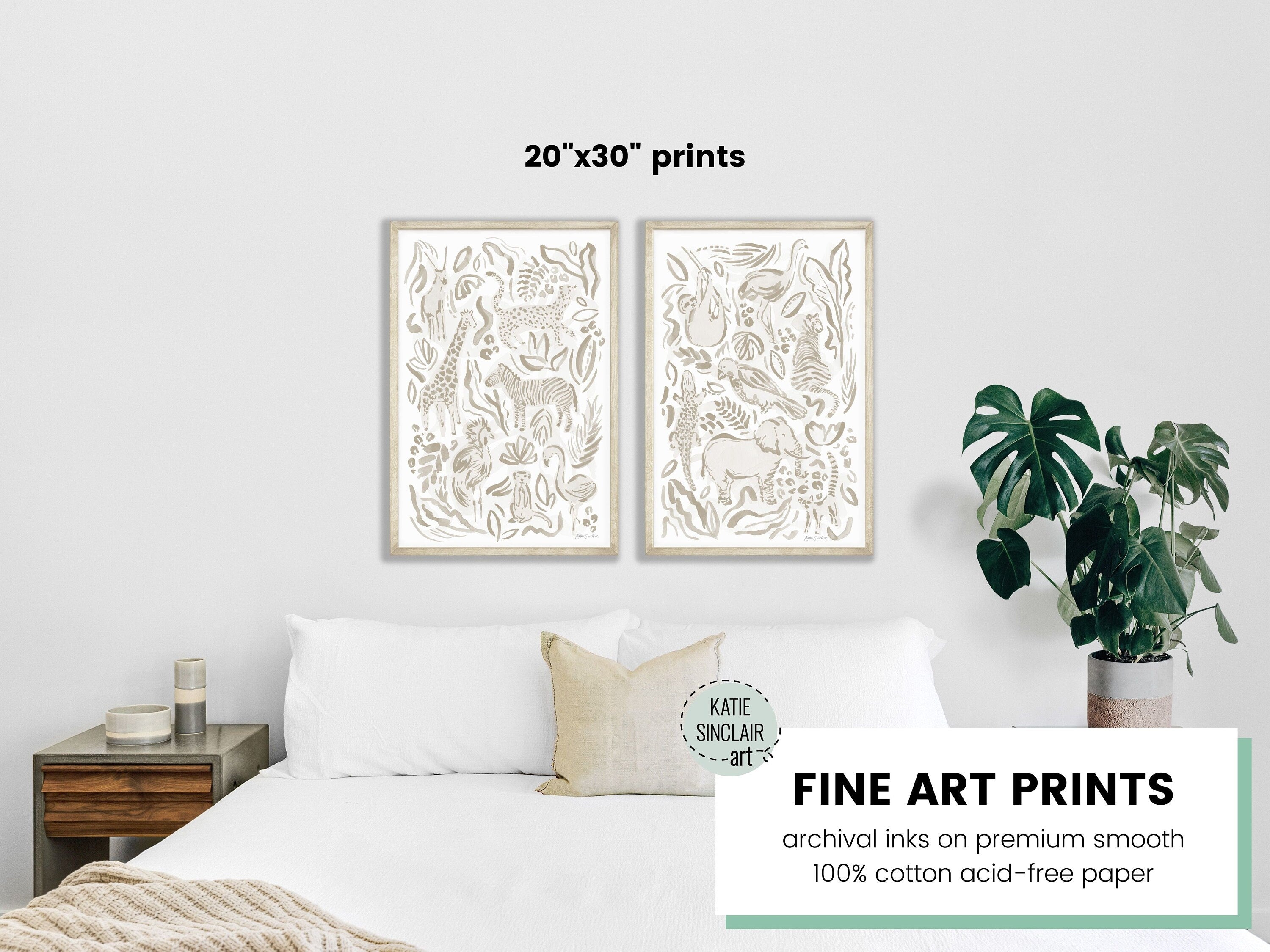A mockup of the safari jungle watercolor print set by Katie Sinclair in the gray colorway over a queen size bed.