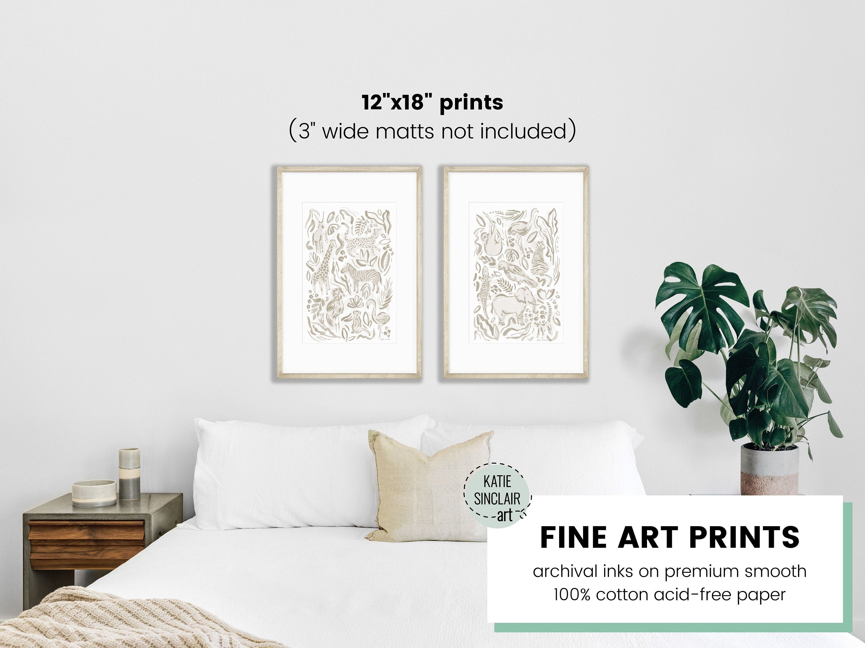 A mockup of the safari jungle watercolor print set by Katie Sinclair in the gray colorway over a queen size bed.