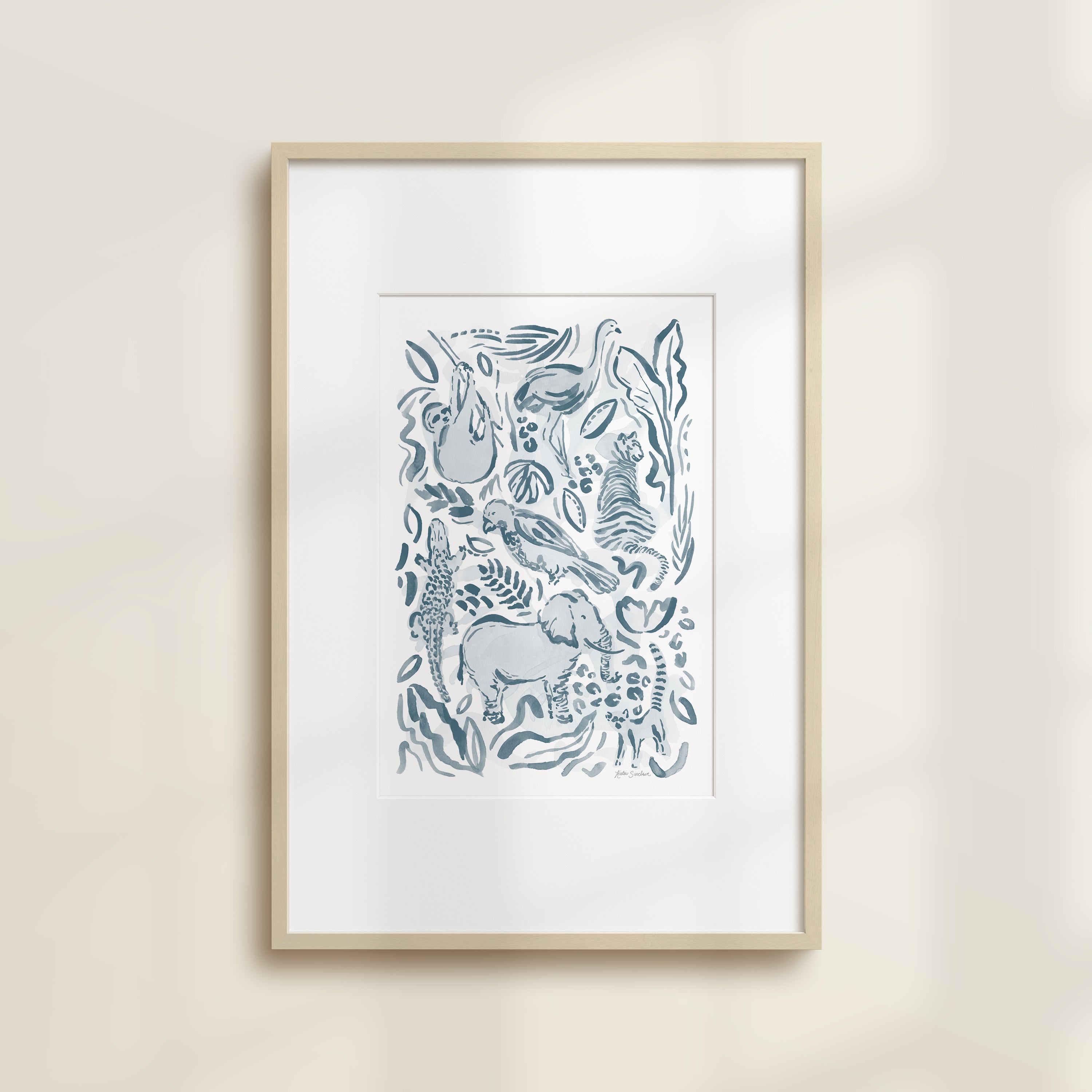 The Safari Jungle Elephant by Katie Sinclair watercolor print in the blue colorway, in a wooden frame with a white mat.