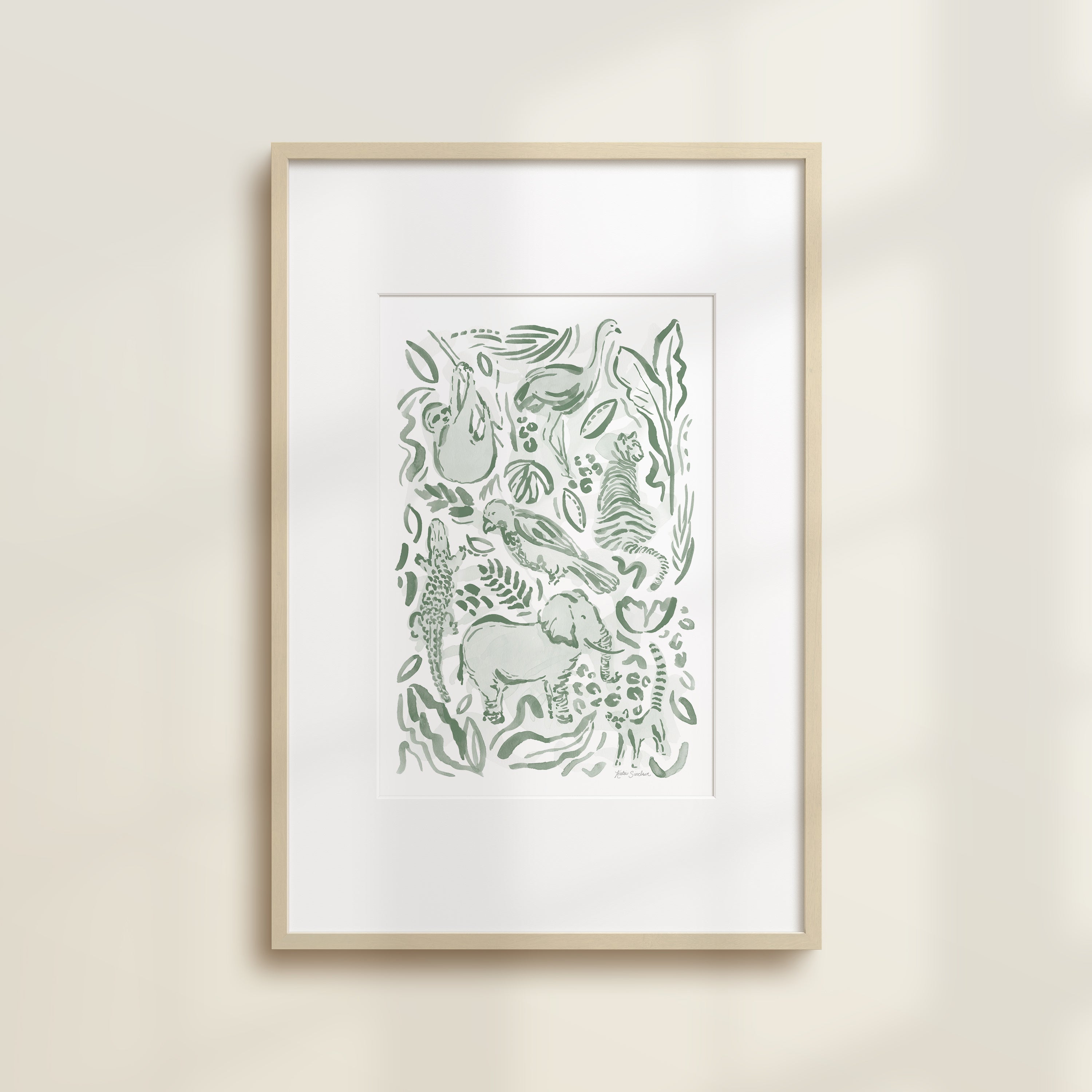 The Safari Jungle Elephant by Katie Sinclair watercolor print in the green colorway, in a wooden frame with a white mat.